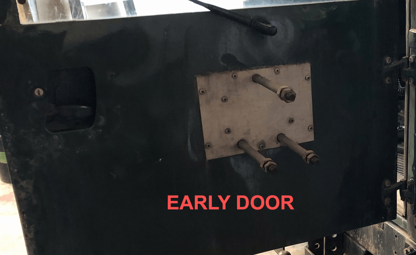 Black door with metal plate and red 'Early Door' text