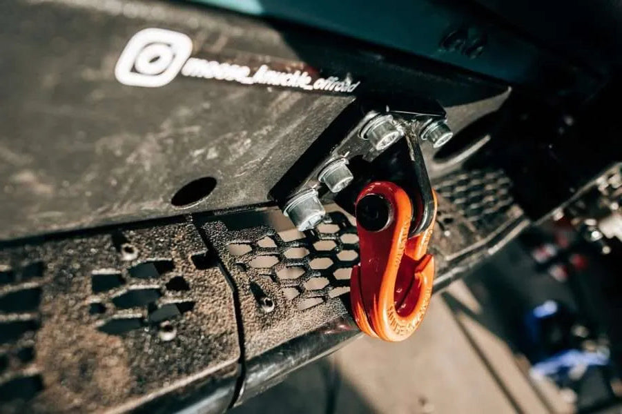Close-up of a black and orange tool on a textured surface with blurred background