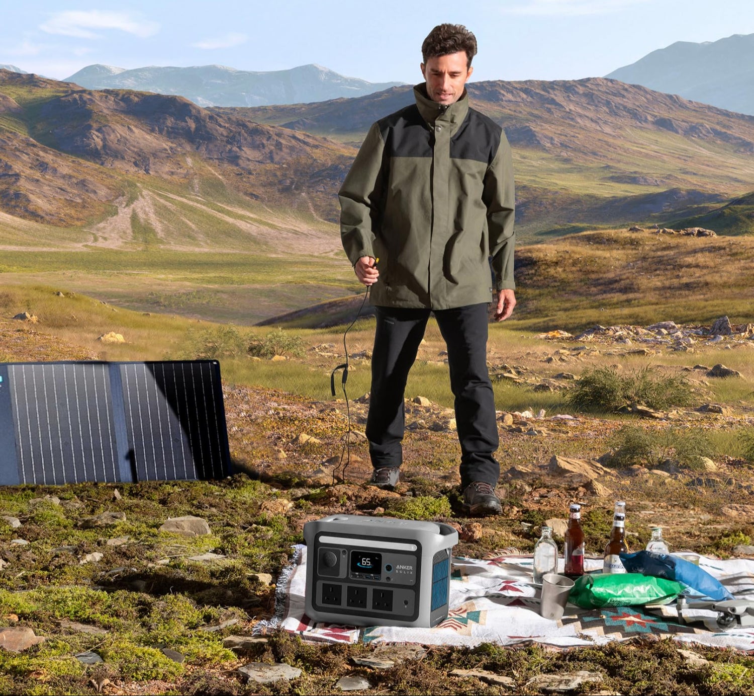 Person standing in a mountainous area with solar panels and electronic equipment, promoting clean power solutions.